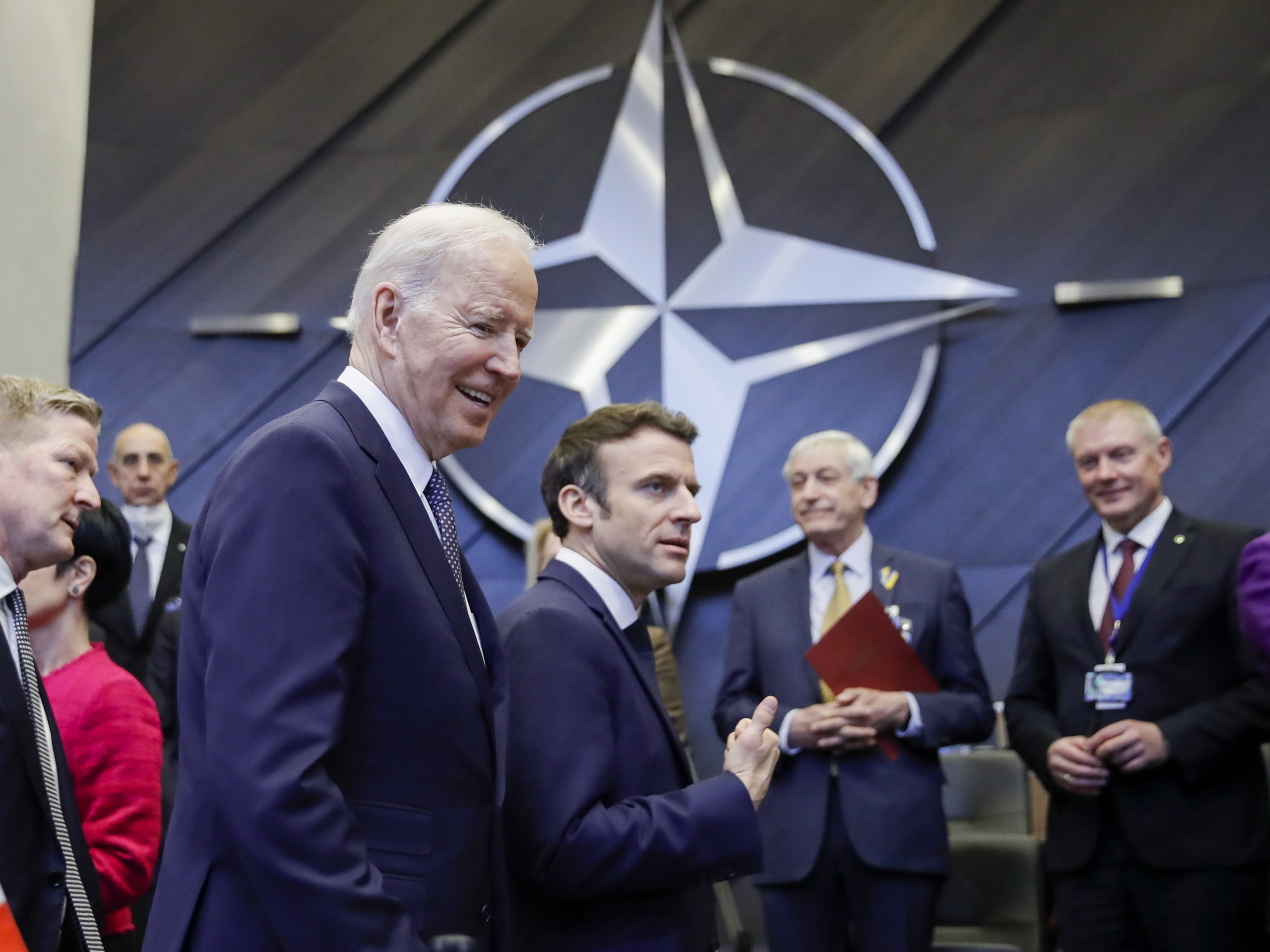 epa09845840 US President Joe Biden (L) and French President Emmanuel Macron (C) arrive for a round table meeting during an extraordinary NATO Summit at the Alliance's headquarters in Brussels, Belgium, 24 March 2022. NATO leaders will address the consequences of Russian President Putin's invasion of Ukraine, discuss the role of China in this crisis, and decide on the next steps to strengthen NATO's deterrence and defence.  EPA/OLIVIER HOSLET