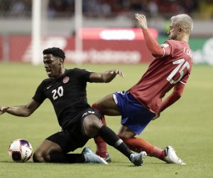 epa09848168 Francisco Calvo (R) of Costa Rica in action against Jonathan David (L) of Canada during the CONCACAF 2022 World Cup Qatar qualifier soccer match between Costa Rica and Canada, at the National Stadium in San Jose, Costa Rica, 24 March 2022.  EPA/Jeffrey Arguedas