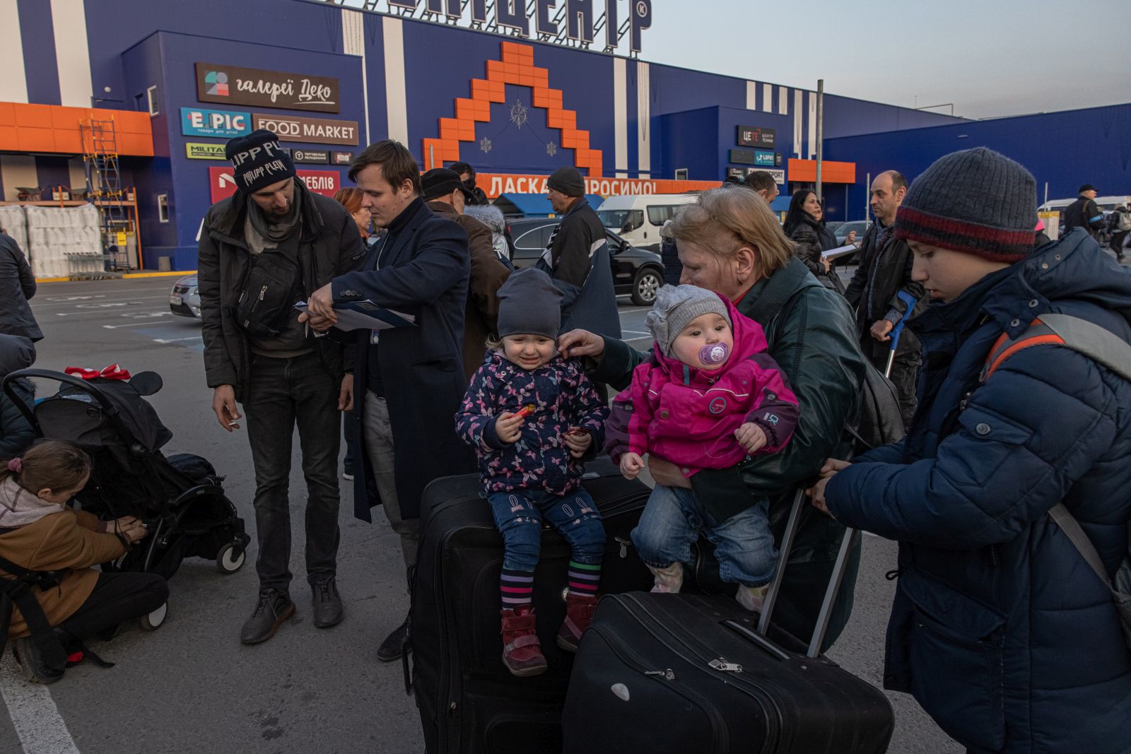 epa09850002 People who fled from the besieged by Russian military southeastern city of Mariupol and occupied Melitopol gather after arriving at the evacuation point in Zaporizhzhia, Ukraine, 25 March 2022. Hundreds of people were evacuated on 25 March from the southeastern cities of Mariupol and Melitopol and arrived in Ukraine's controlled area by buses and their own cars. Almost 100,000 residents remain trapped and live in 'inhuman conditions' without food and water in the ruined city of Mariupol, amid Russia's 'constant shelling', Ukrainian president Volodymyr Zelenskyy says.  EPA/ROMAN PILIPEY