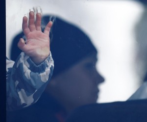 The hand of a child is seen through a bus window at a temporary accommodation centre, after fleeing Russian invasion of Ukraine, in Korczowa, Poland, March 3, 2022. REUTERS/Yara Nardi Photo: YARA NARDI/REUTERS