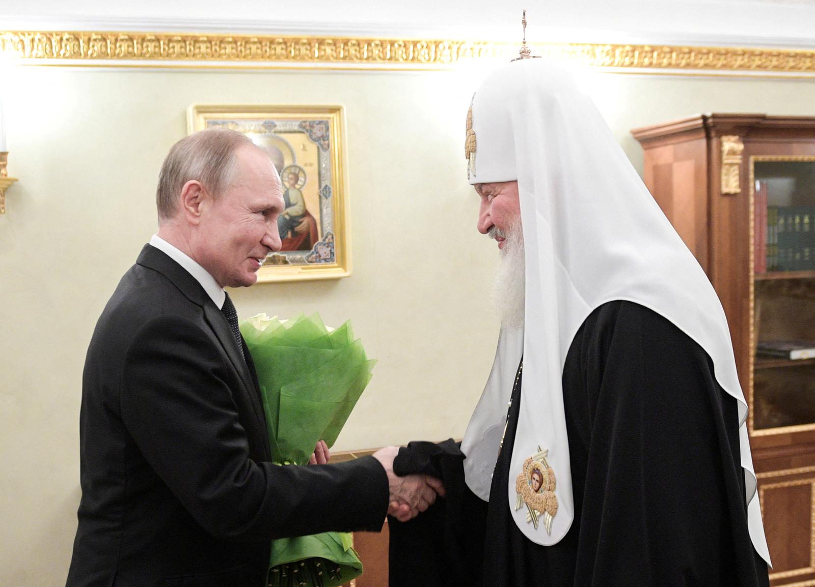 FILE PHOTO: Russian President Vladimir Putin congratulates Patriarch Kirill of Moscow and All Russia on the day of the 11th anniversary of his enthronement in Moscow, Russia February 1, 2020. Sputnik/Alexei Druzhinin/Kremlin via REUTERS ATTENTION EDITORS - THIS IMAGE WAS PROVIDED BY A THIRD PARTY./File Photo Photo: SPUTNIK/REUTERS