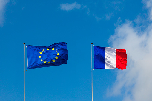 EU flag and France flag are on blue sky. Concept relations between Europe and France