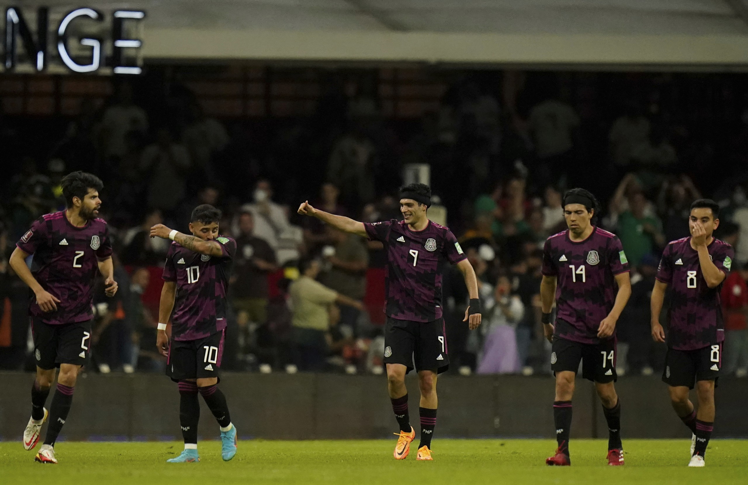 Mexico's Raul Jimenez, center, celebrates after scoring his side's second goal against El Salvador during a qualifying soccer match for the FIFA World Cup Qatar 2022 in Mexico City, Wednesday, March 30, 2022. (AP Photo/Eduardo Verdugo)