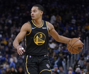 Golden State Warriors guard Jordan Poole brings the ball up during the second half of Game 1 of the team's NBA basketball first-round playoff series against the Denver Nuggets in San Francisco, Saturday, April 16, 2022. (AP Photo/Jeff Chiu)