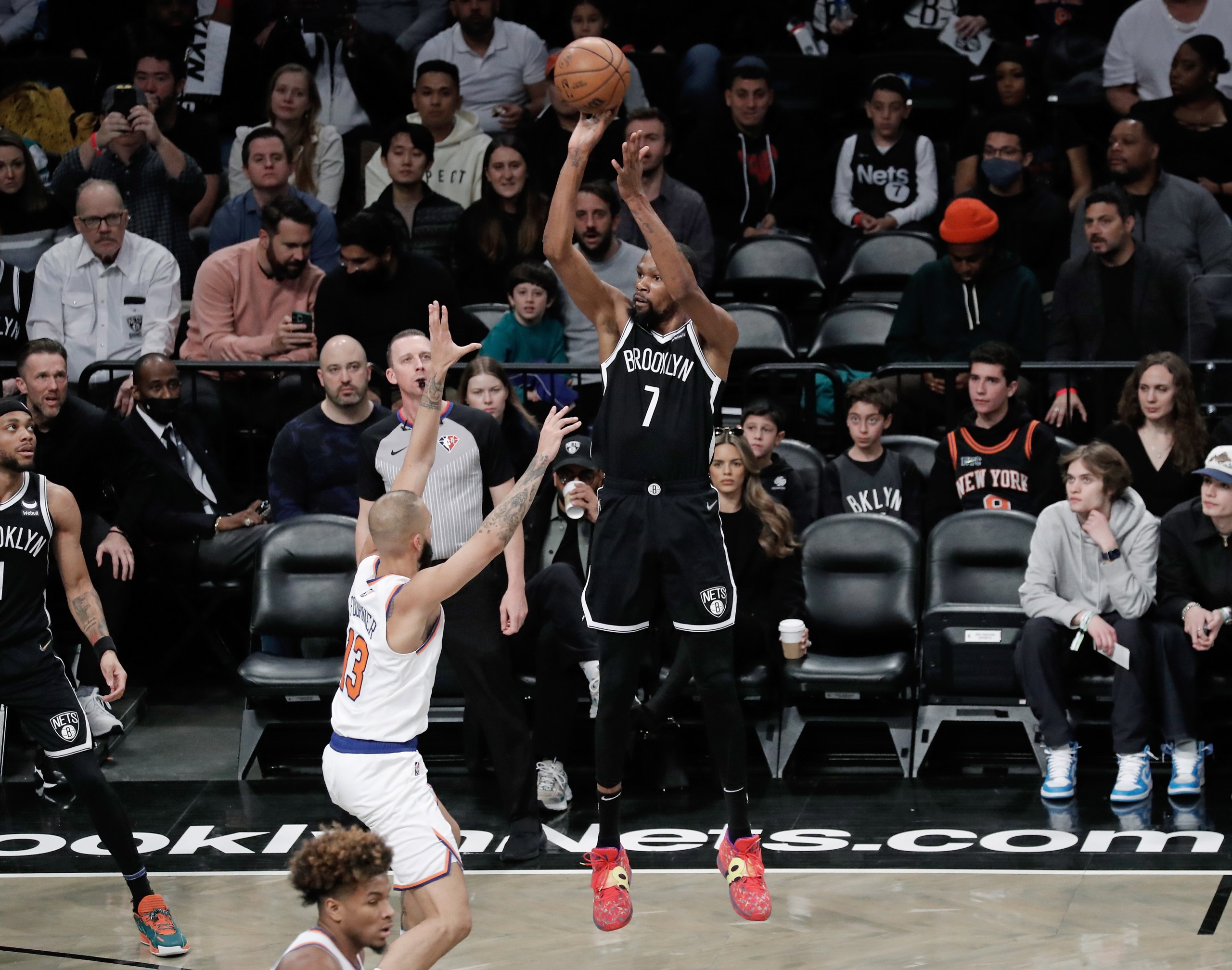 epa09822673 Brooklyn Nets forward Kevin Durant shoots (C) shoots over New York Knicks guard Evan Fournier during the first half of the NBA basketball game between the Brooklyn Nets and the New York Knicks  at Barclays Center in  Brooklyn, New York, USA, 13 March  2022.  EPA/Peter Foley SHUTTERSTOCK OUT