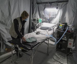 epa09824302 A doctor prepares for admission of patients in the hospital deployed by American doctors from the 'Samaritan's Purse' organization in an underground parking in the King Cross Leopolis shopping mall, amid Russia's military operation in Ukraine, at the village of Sokilnyky, near Lviv, Ukraine, 14 March 2022. Russian troops entered Ukraine on 24 February prompting the country's president to declare martial law and triggering a series of announcements by Western countries to impose severe economic sanctions on Russia.  EPA/MYKOLA TYS