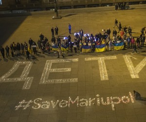 epa09843117 People light candles during the Light for Mariupol peace rally for people who died during a shelling in the eastern Ukrainian city of Mariupol, in front of the National Theatre building in Prague, Czech Republic, 22 March 2022. People created a large luminous sign ‘ДЕТИ’, which means 'children' in Russian, the same sign that was meant to protect the theatre in Mariupol against a bomb attack. At least 30 people were killed and about 100 others injured during this large-scale attack.  EPA/MARTIN DIVISEK