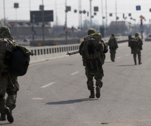 epa09844619 Ukrainian soldiers patrol on the outskirt of Kiev (Kyiv), Ukraine, 23 March 2022. Russian troops entered Ukraine on 24 February prompting the country's president to declare martial law and triggering a series of announcements by Western countries to impose severe economic sanctions on Russia.  EPA/ATEF SAFADI