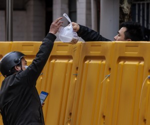 epa09861669 A man delivers food to a man in the compound under quarantine amid the lockdown, in Puxi side of the city, in Shanghai, China, 31 March 2022. Shanghai city imposed a strict lockdown amid the COVID-19 resurgence. A complete lockdown hits the two biggest areas in the city, divided by the Huangpu River. East of the Huangpu River, Pudong area, lockdown started on 28 March while west area, Puxi, will have a lockdown from 01 April.  EPA/ALEX PLAVEVSKI