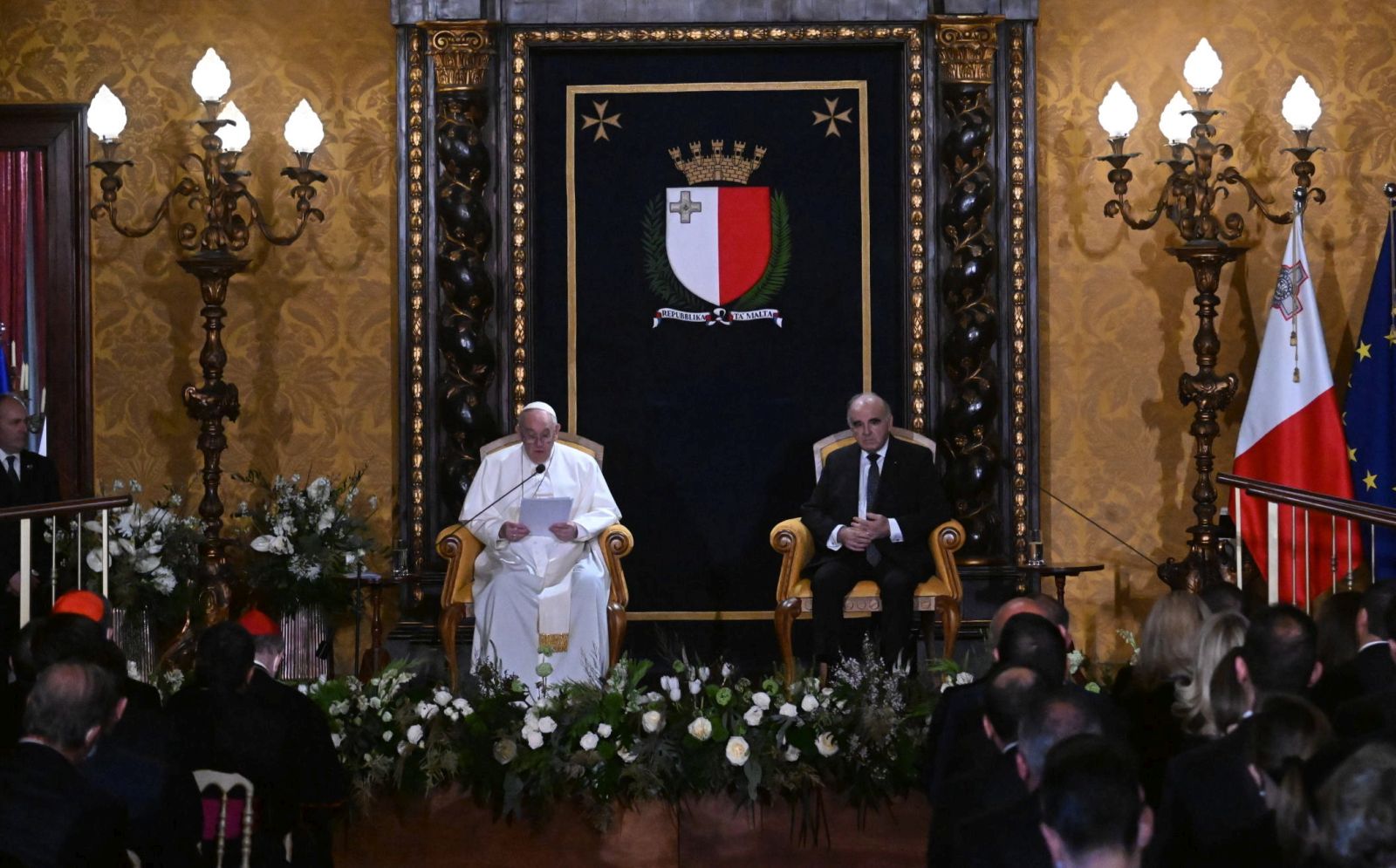 epa09865170 Pope Francis (L) and Malta's President George Vella (R) prepare to address the authorities and the diplomatic corps in the Grand Council Chamber of the Grand Master's presidential Palace in Valletta, Malta, 02 April 2022.  EPA/CIRO FUSCO