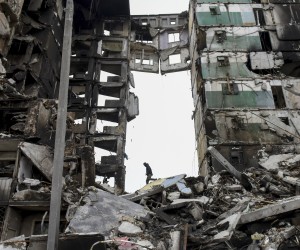 epaselect epa09872658 A man climbs on the destroyed apartment block in the city of Borodyanka near Kyiv (Kiev), Ukraine, 05 April 2022. On 24 February, Russian troops had entered Ukrainian territory in what the Russian president declared a 'special military operation', resulting in fighting and destruction in the country, a huge flow of refugees, and multiple sanctions against Russia.  EPA/OLEG PETRASYUK