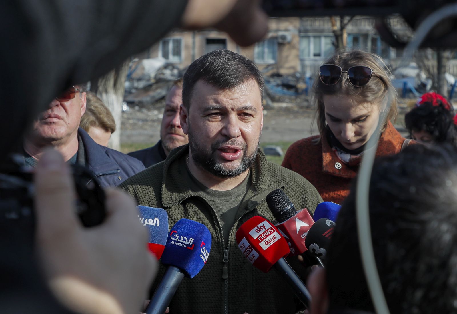 epa09884753 Head of the self-proclaimed Donetsk People's Republic Denis Pushilin (C) speaks with journalists at the place where, two weeks ago, an apartment building was destroyed as a result of a 'Uragan' missile hit, in Donetsk, Ukraine, 11 April 2022. In the self-proclaimed Donetsk People's Republic (DPR), 261 people died from 01 April to 07 April, the press service of the Commissioner for Human Rights in the republic reports. In total, 6,271 deaths have been registered in the DPR since the spring of 2014, including 96 children. On 24 February Russian troops had entered Ukrainian territory in what the Russian president declared a 'special military operation', resulting in fighting and destruction in the country, a huge flow of refugees, and multiple sanctions against Russia.  EPA/SERGEI ILNITSKY