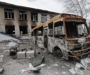 epa09886587 Debris of a school bus near a damaged school that was a base of Russian troops in Bohdanivka village not far from Brovary, Kyiv's area, Ukraine, 12 April 2022. Some cities and villages had recently been recaptured by the Ukrainian army from Russian forces and now people try to restore normal life there. Russian troops entered Ukraine on 24 February resulting in fighting and destruction in the country and triggering a series of severe economic sanctions on Russia by Western countries.  EPA/SERGEY DOLZHENKO