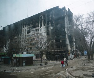 epa09887016 A picture taken during a visit to Mariupol organized by the Russian military shows local people cary water near devesteted and burned apartment building in downtown Mariupol, Ukraine, 12 April 2022. For more than a month, hostilities have continued in the city. There is no water, electricity, gas or communications. Shops, pharmacies and hospitals are closed. 250 thousand inhabitants left the city, about 300 thousand still remain. During the hostilities, up to 70 percent of the housing stock of Mariupol was destroyed and five thousand residents of the city was killed said the new mayor of the city Konstantin Ivashchenko. On 24 February Russian troops had entered Ukrainian territory in what the Russian president declared a 'special military operation', resulting in fighting and destruction in the country, a huge flow of refugees, and multiple sanctions against Russia.  EPA/SERGEI ILNITSKY