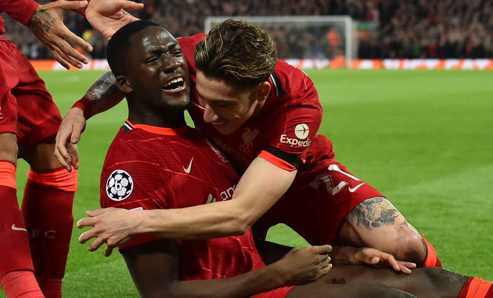 epa09888561 Liverpool's Ibrahima Konate (L) celebrates with teammate Kostas Tsimikas after scoring the 1-0 goal during the UEFA Champions League quarter final, second leg soccer match between Liverpool FC and Benfica Lisbon in Liverpool, Britain, 13 April 2022.  EPA/PETER POWELL