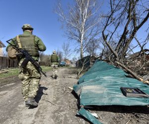 epa09890670 Ukrainian servicemen wqalk along a  damaged street in the north of Kyiv (Kiev), Ukraine, 14 April 2022. On 24 February, Russian troops had entered Ukrainian territory in what the Russian president declared a 'special military operation', resulting in fighting and destruction in the country, a huge flow of refugees, and multiple sanctions against Russia.  EPA/OLEG PETRASYUK