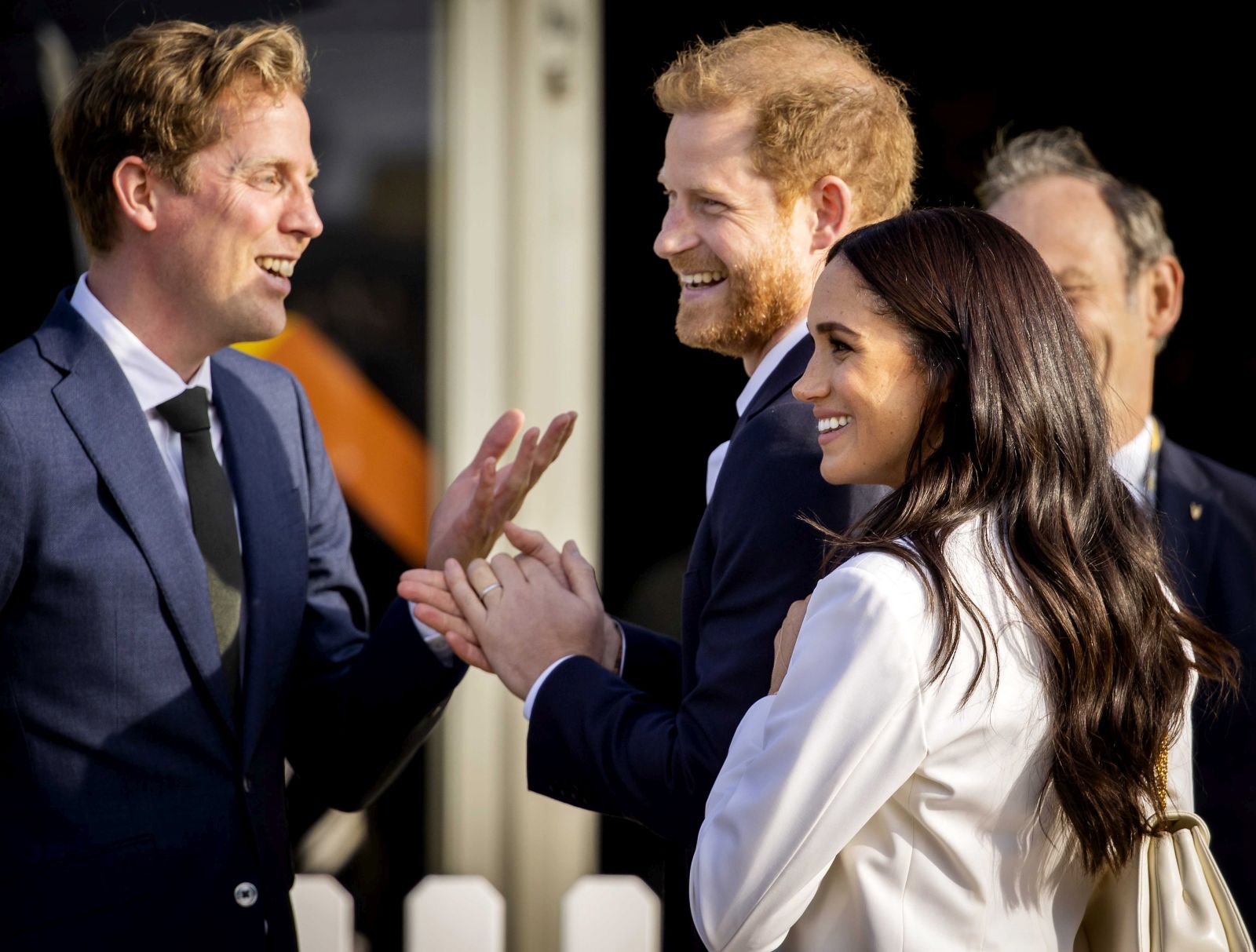 epa09891711 Britain's Prince Harry, Duke of Sussex (C) and his wife, Meghan, Duchess of Sussex (R) arrive on the Yellow Carpet before the start of the Invictus Games in The Hague, The Netherlands, 15 April 2022. The Invictus Games will take place from 16 to 22 April 2022 at the Zuiderpark and are intended for military personnel and veterans who have been psychologically or physically injured in service.  EPA/REMKO DE WAAL