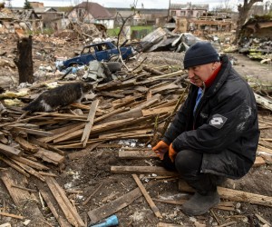 epa09896276 A man plays with his cat near a destroyed house in Borodyanka, town of Kyiv (Kiev) area, Ukraine, 18 April 2022. On 24 February, Russian troops had entered Ukrainian territory in what the Russian president declared a 'special military operation', resulting in fighting and destruction in the country, a huge flow of refugees, and multiple sanctions against Russia.  EPA/OLEG PETRASYUK