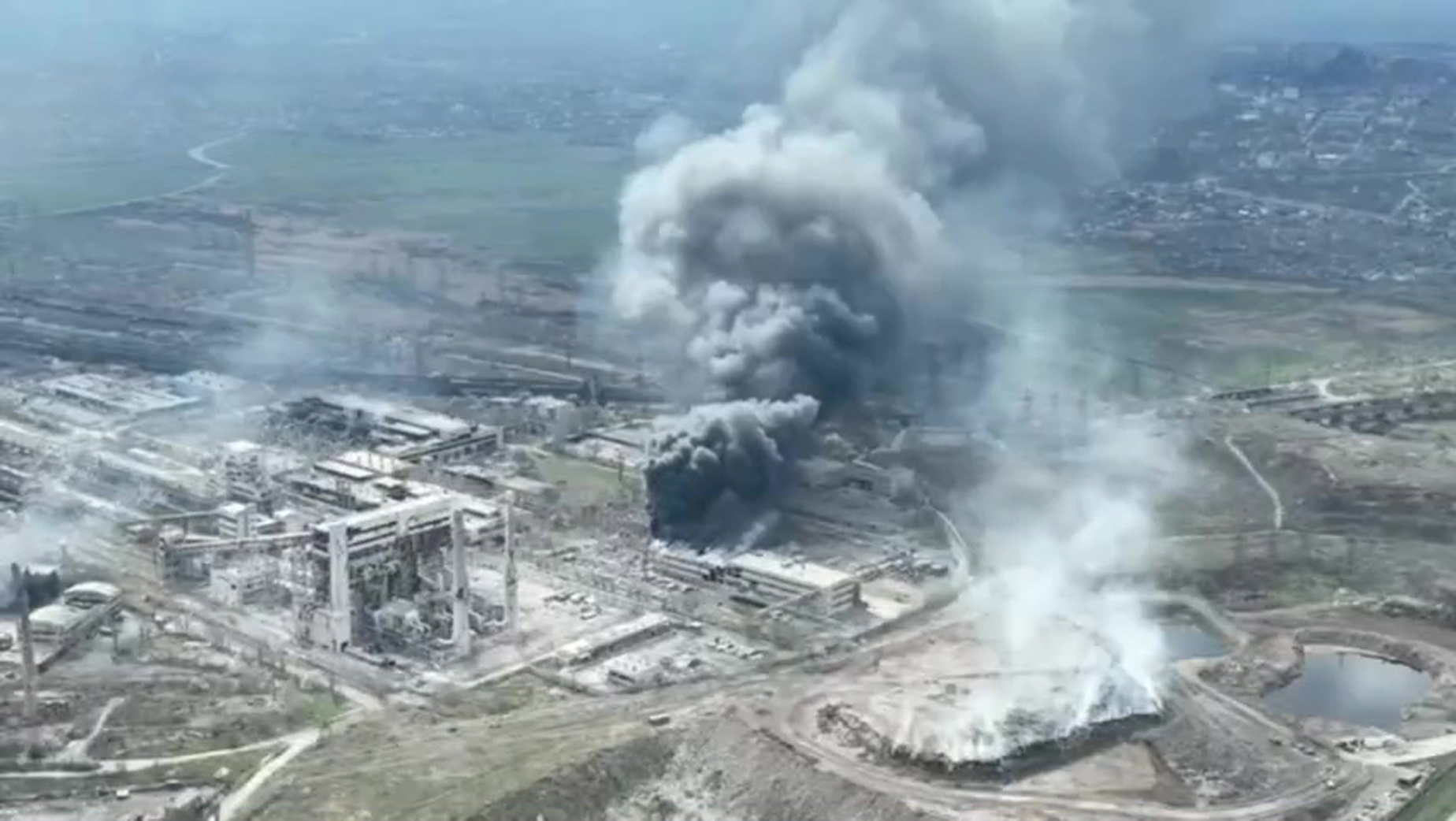 epa09896967 A frame grab from an undated handout drone video first published by DPR militia commander Alexander Khodakovsky and made available by the Mariupol City Council shows smoke rising from the Azovstal steel plant during airstrikes in Mariupol, eastern Ukraine, 18 April (issued 19 April 2022). The Russian Defence Ministry on 19 April 2022 issued a statement calling on the Ukrainian forces in Mariupol "to cease any hostilities and lay down their arms. All who lay down their weapons are guaranteed the preservation of life." The city council on 18 April 2022 via their official Telegram channel said that at least 1,000 civilians are sheltering in the underground shelters of the metallurgical plant, and that heavy bombs were dropped on the Azovstal plant by Russian forces.  EPA/MARIUPOL CITY COUNCIL HANDOUT  HANDOUT EDITORIAL USE ONLY/NO SALES