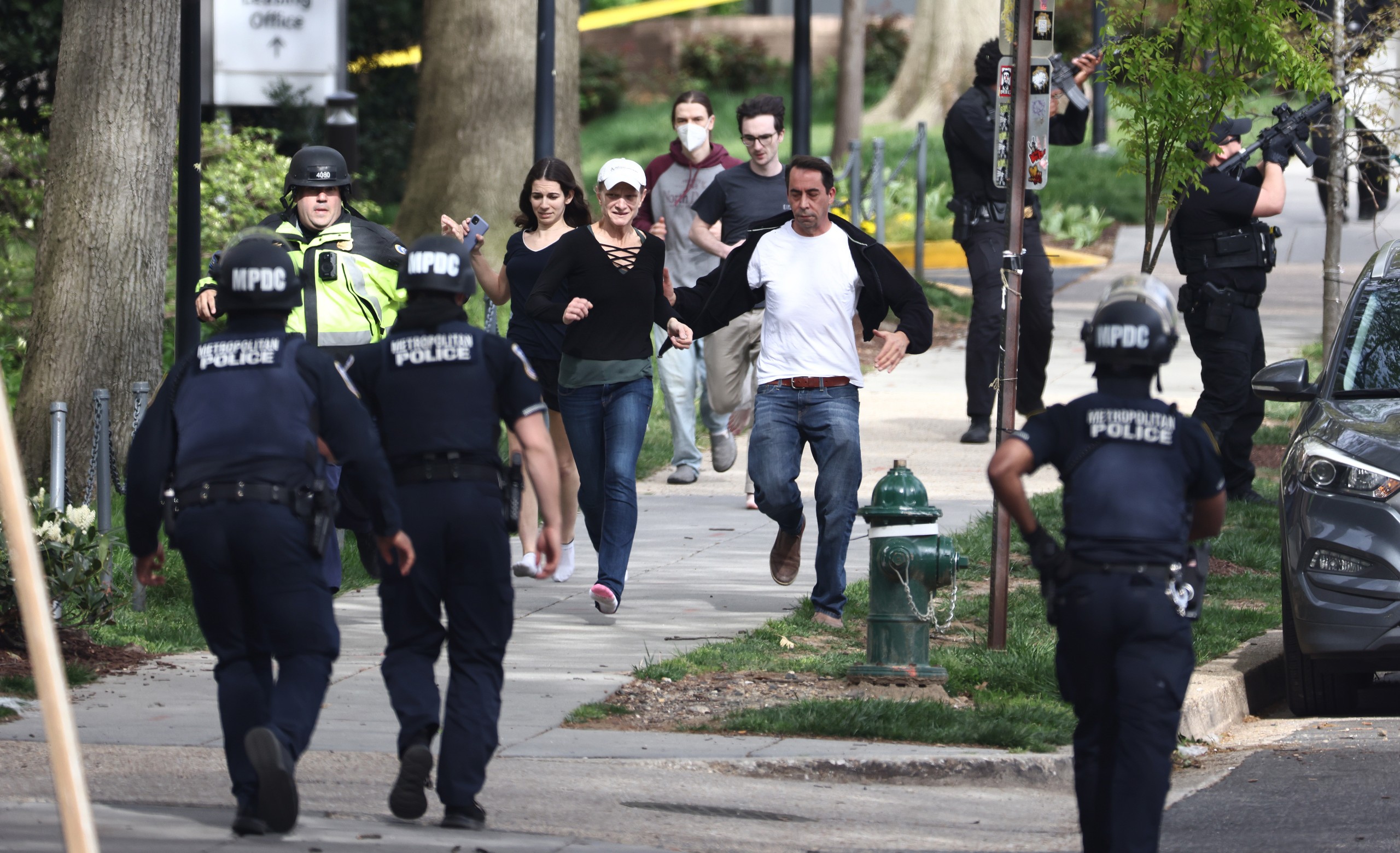 epaselect epa09903332 People are escorted to safety as Washington DC Metropolitan Police and US Secret Service investigate at the scene of a reported shooting near the Edmund Burke School in Northwest Washington, DC, USA, 22 April 2022.  EPA/JIM LO SCALZO