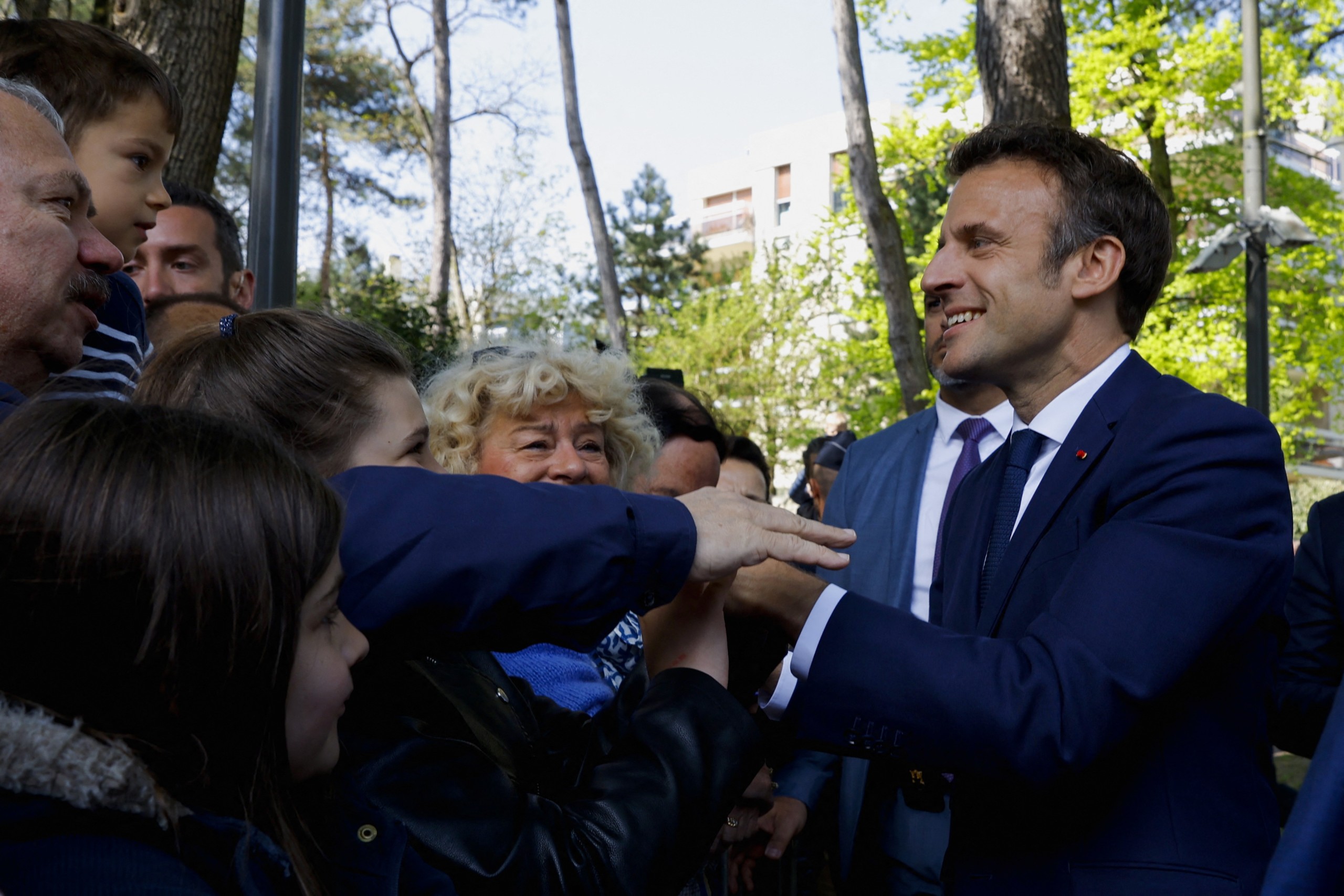 epa09906375 French President and candidate for re-election, Emmanuel Macron (R) greets supporters as he arrives to vote in the second round of the 2022 French presidential election, at a polling station in Le Touquet, France, 24 April 2022.  EPA/GONZALO FUENTES / POOL  MAXPPP OUT