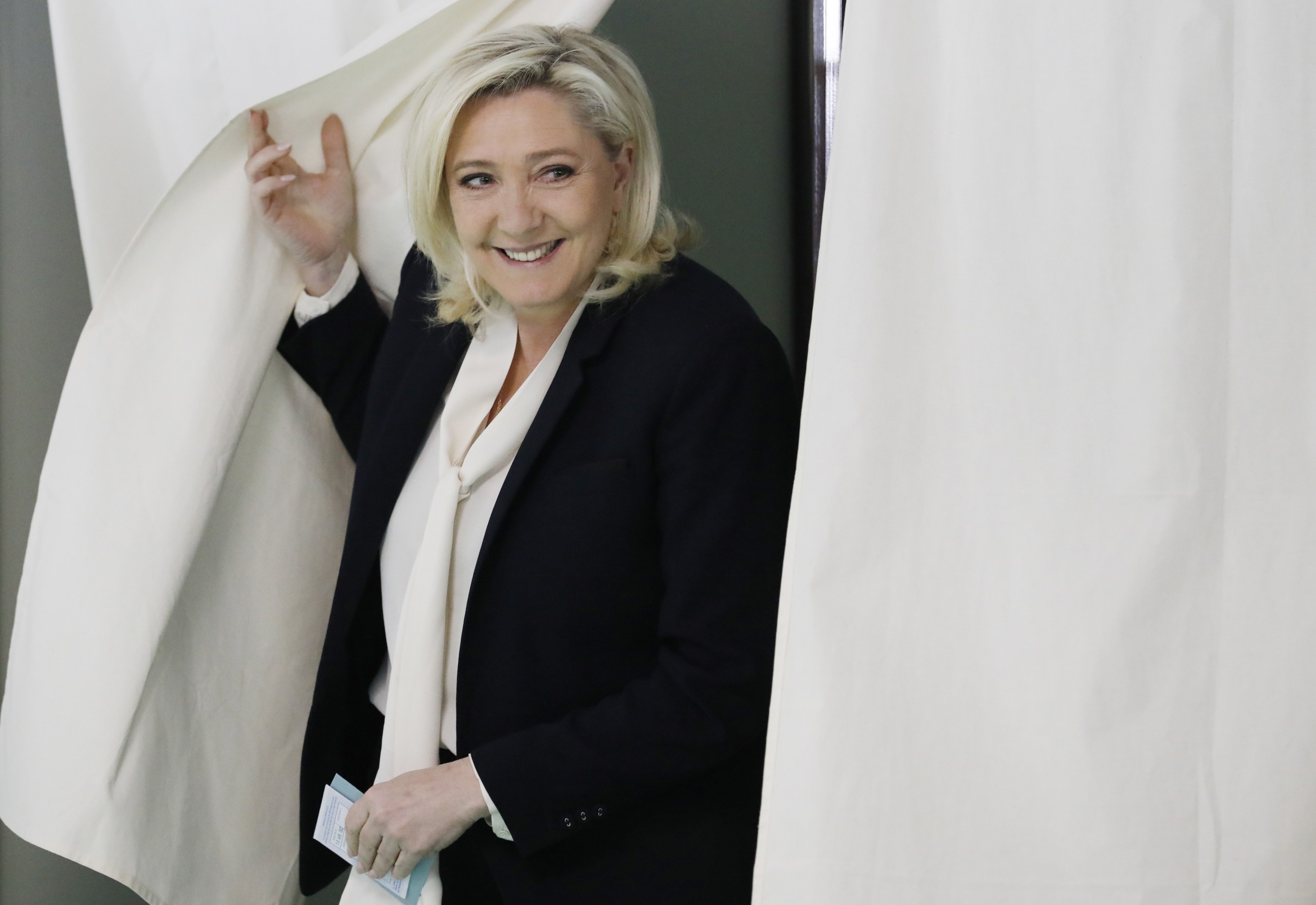 epaselect epa09906123 French far-right Rassemblement National (RN) party candidate for the French presidential election Marine Le Pen  leaves the voting booth at a polling station for the second round of the French presidential elections in Henin-Beaumont, France, 24 April 2022.  EPA/Ian Langsdon