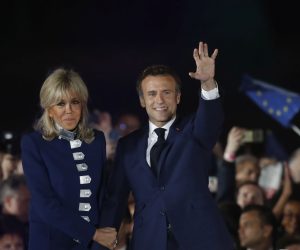 epa09907439 French President Emmanuel Macron and his wife Brigitte Macron celebrate on the stage after winning the second round of the French presidential elections at the Champs-de-Mars after Emmanuel Macron won the second round of the French presidential elections in Paris, France, 24 April 2022. Emmanuel Macron defeated Marine Le Pen in the final round of France's presidential election, with exit polls indicating that Macron is leading with approximately 58 percent of the vote.  EPA/GUILLAUME HORCAJUELO