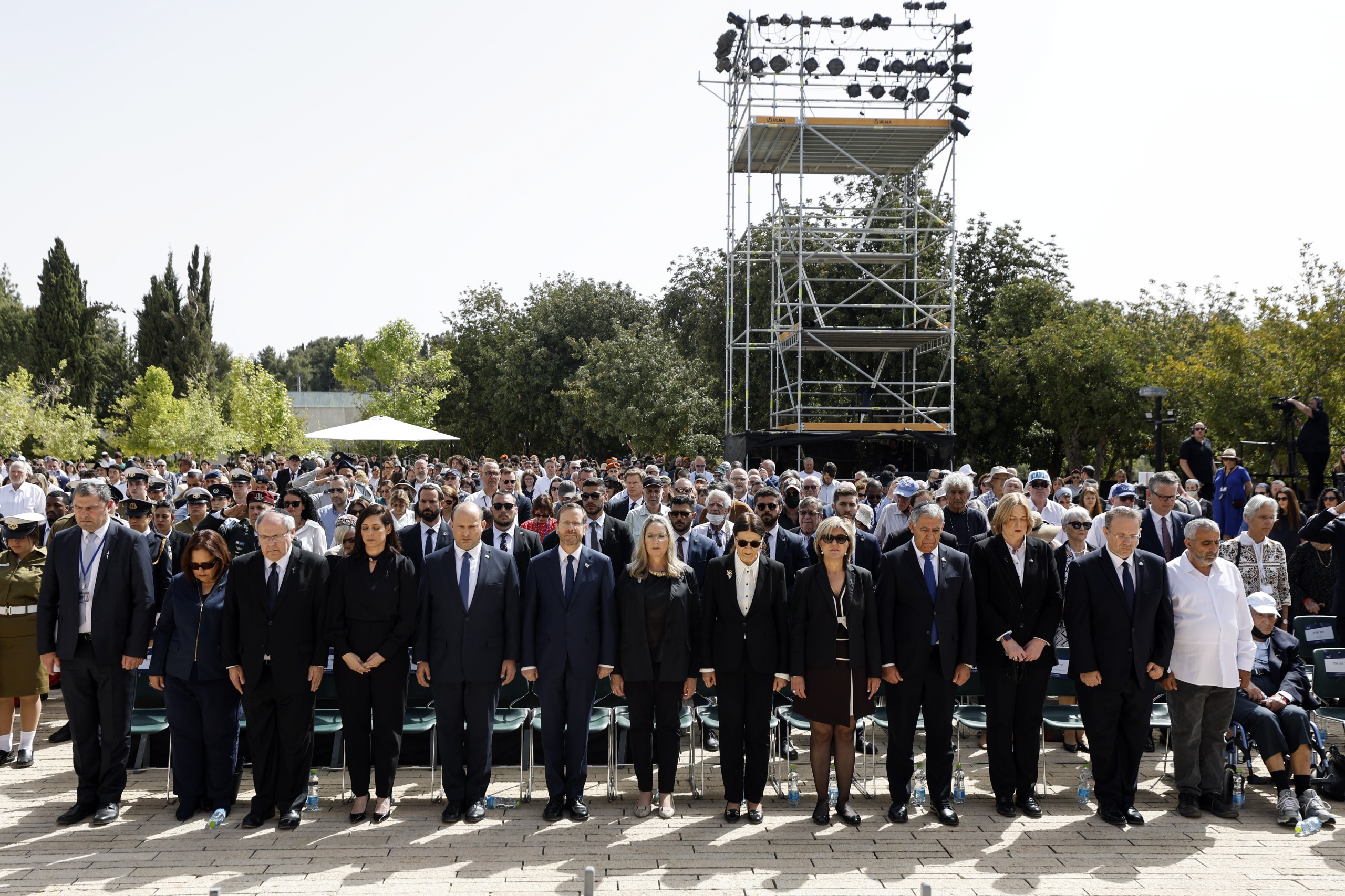 epa09913814 Israeli Prime Minister Naftali Bennett (5-L) and President Isaac Herzog (6-L) stand  together with other officials during the ceremony marking Holocaust Remembrance Day at Warsaw Ghetto Square at the Yad Vashem Holocaust Memorial in Jerusalem, Israel, 28 April 2022.  EPA/AMIR COHEN / POOL