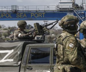 epa09917501 A picture taken during a visit to Mariupol organized by the Russian military shows Russian servicemen guard the territory of the cargo sea port in Mariupol, Ukraine, 29 April 2022. Mariupol is located on the northern coast of the Sea of Azov, it is one of the largest commercial seaports in Ukraine. Almost 500 thousand people previously lived in the city. On 16 April, the Russian Defense Ministry announced that the urban area of Mariupol had been cleared of the Ukrainian military, and their remnants were completely blocked on the territory of the Azovstal metallurgical plant. On 24 February Russian troops had entered Ukrainian territory in what the Russian president declared a 'special military operation', resulting in fighting and destruction in the country, a huge flow of refugees, and multiple sanctions against Russia.  EPA/SERGEI ILNITSKY