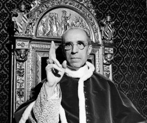 FILE - In this file photo dated Sept. 1945, Pope Pius XII, wearing the ring of St. Peter, raises his right hand in a papal blessing at the Vatican. The Vatican’s chief librarian and archivists said Thursday, Feb. 20, 2020 that all researchers _ regardless of nationality, faith and ideology _ were welcome to request access to the soon-to-open Vatican’s apostolic library on Pope Pius XII starting March 2.  (AP Photo, File)