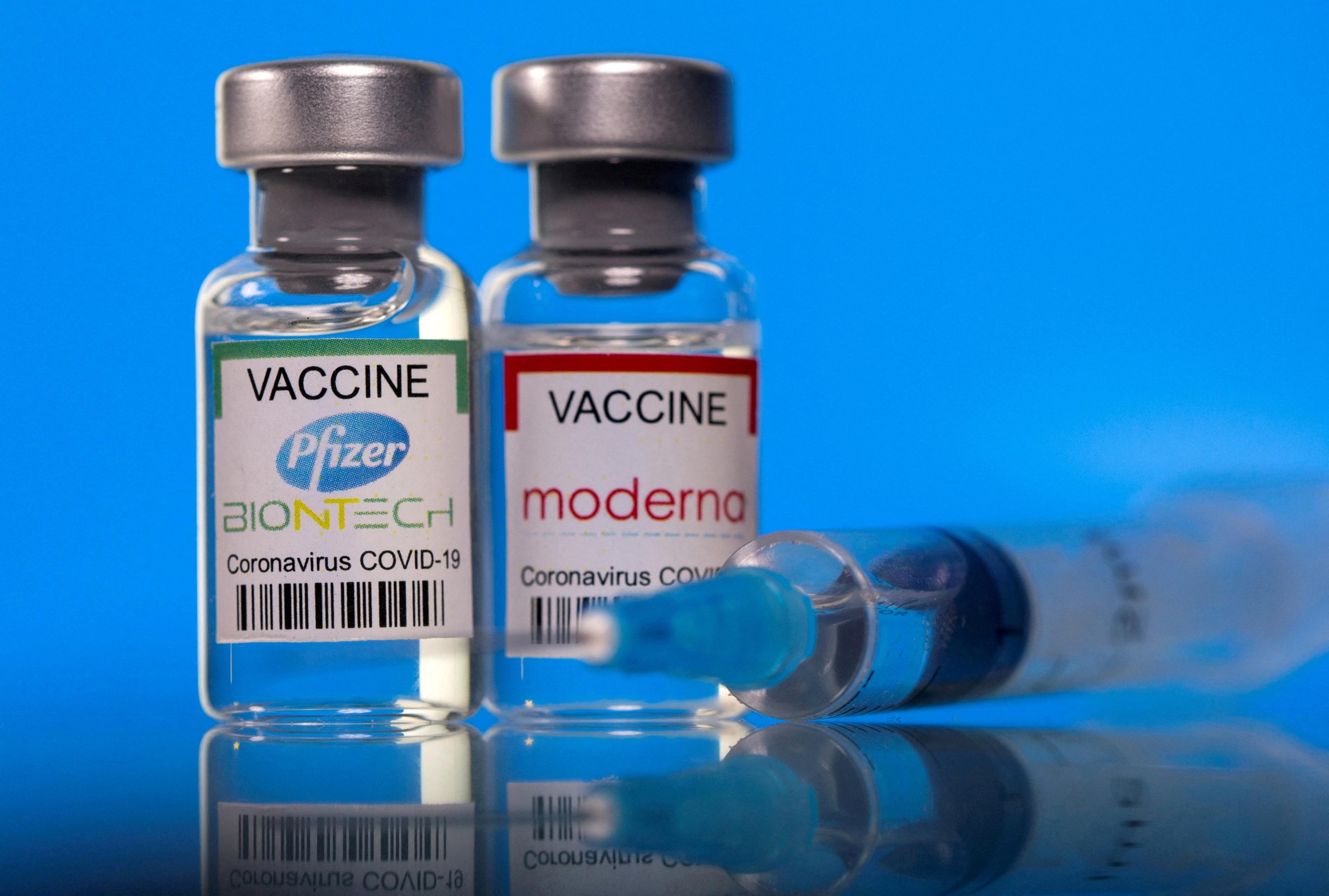 FILE PHOTO: Vials with Pfizer-BioNTech and Moderna coronavirus disease (COVID-19) vaccine labels are seen in this illustration picture taken March 19, 2021. REUTERS/Dado Ruvic/Illustration/File Photo Photo: DADO RUVIC/REUTERS