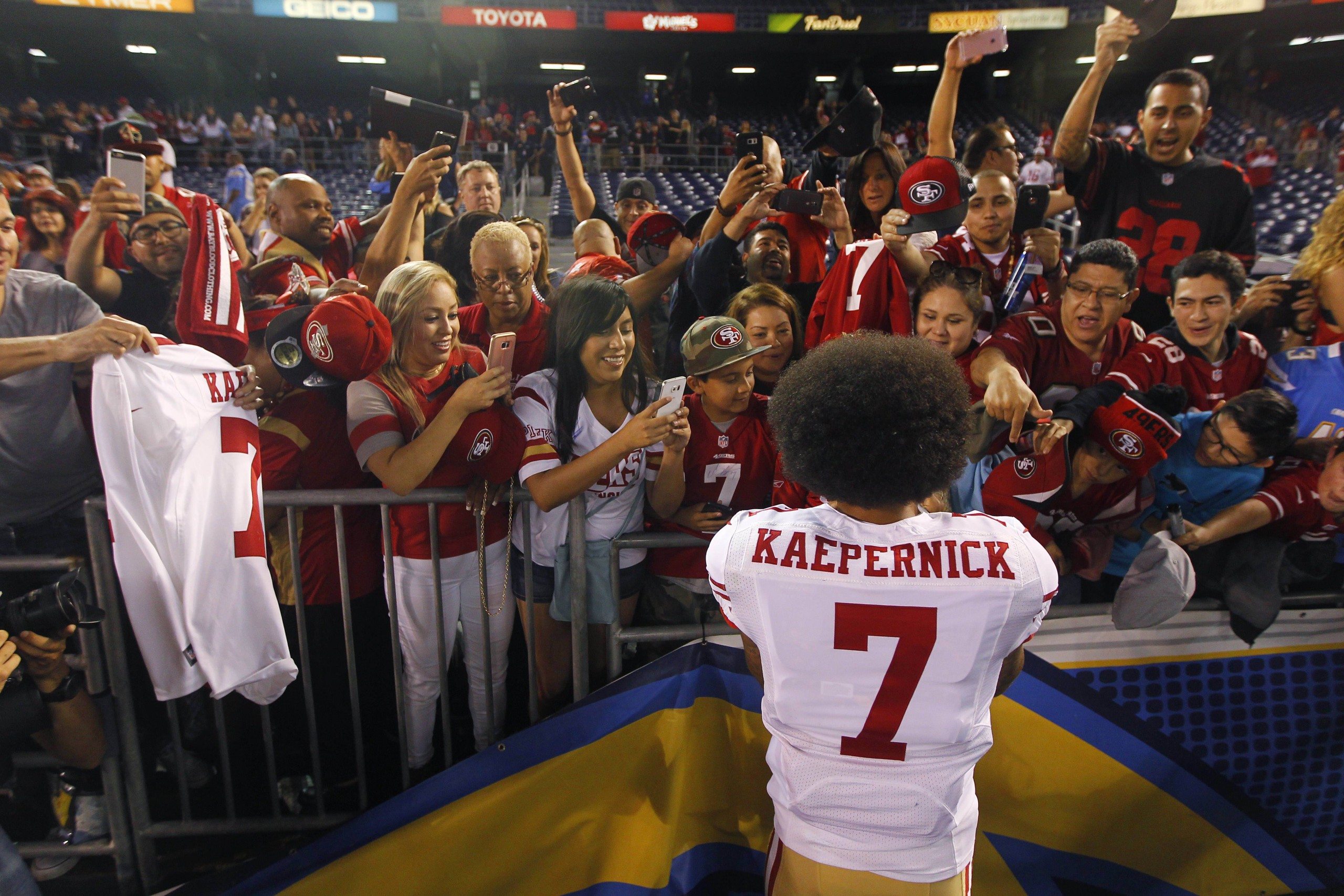 September 1, 2016 - San Diego, CA, USA - SAN DIEGO, CA - SEPTEMBER 1, 2016 - San Francisco 49ers quarterback Colin Kaepernick signs autographs for fans after a preseason game against the San Diego Chargers. Kaepernick kneeled during the national anthem before the game. San Francisco 49ers quarterback Colin Kaepernick takes photos with fans after a preseason game against the San Diego Chargers. Kaepernick kneeled during the national anthem before the game.  - ZUMAs44_