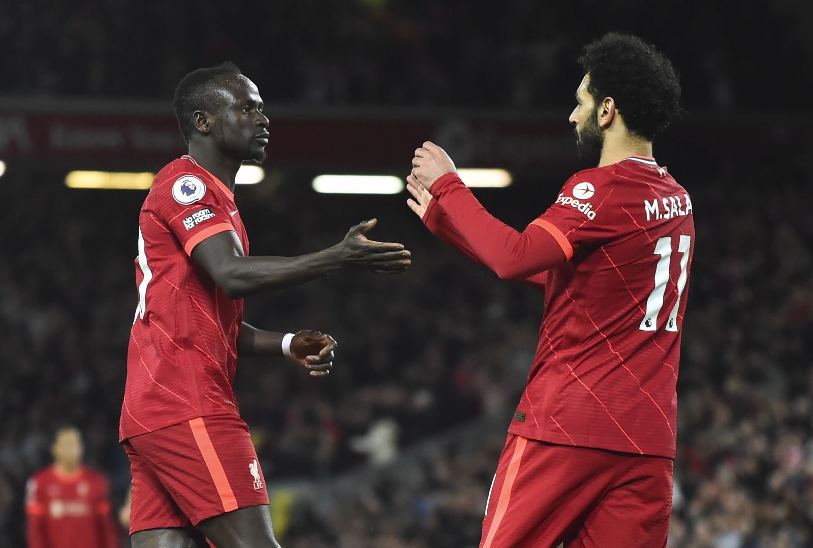 epa09897930 Sadio Mane (L) of Liverpool celebrates with teammate Mohamed Salah (R) after scoring the 3-0 goal during the English Premier League soccer match between Liverpool and Manchester United in Liverpool, Britain, 19 April 2022.  EPA/PETER POWELL EDITORIAL USE ONLY. No use with unauthorized audio, video, data, fixture lists, club/league logos or 'live' services. Online in-match use limited to 120 images, no video emulation. No use in betting, games or single club/league/player publications