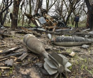 epa09898952 A local man looks at rest of bombs that litters a field in Ivanivka village, Chernihiv region, UKraine, 20 April 2022. On 24 February Russian troops had entered Ukrainian territory resulting in fighting and destruction in the country, a huge flow of refugees, and multiple sanctions against Russia.  EPA/OLEG PETRASYUK