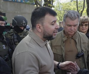 epa09917347 A picture taken during a visit to Luhansk organized by the Russian military shows Head of the self-proclaimed Donetsk People's Republic Denis Pushilin (L) and the new mayor of the city of Mariupol Konstantin Ivashchenko (C) speak with a local woman near the place where humanitarian aid is distributed in Mariupol, Ukraine, 29 April 2022. According to Eduard Basurin, spokesman of the self-proclaimed Donetsk People's Republic (DPR): 'after two months of continued hostility in the city, the main battles in Mariupol are over'. On 24 February Russian troops had entered Ukrainian territory in what the Russian president declared a 'special military operation', resulting in fighting and destruction in the country, a huge flow of refugees, and multiple sanctions against Russia.  EPA/SERGEI ILNITSKY