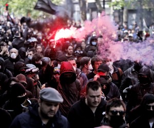 epa09920389 Demonstrators light red flares as they take part in the annual May Day march in Paris, France, 01 May 2022. Labour Day, also known as International Workers' Day or May Day, is observed annually on 01 May worldwide to celebrate the economic and social achievements of workers as well as fight for laborers rights.  EPA/YOAN VALAT