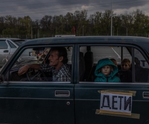 epa09922934 A family waits inside a car with a sign reading "Children", after arriving from Mariupol to the evacuation point in Zaporizhzhia, Ukraine, 02 May 2022. Thousands of people who still remained trapped in Mariupol and others occupied by the Russian army areas in South Ukraine wait to be evacuated to Ukraine's controlled area by buses and their own cars.  EPA/ROMAN PILIPEY