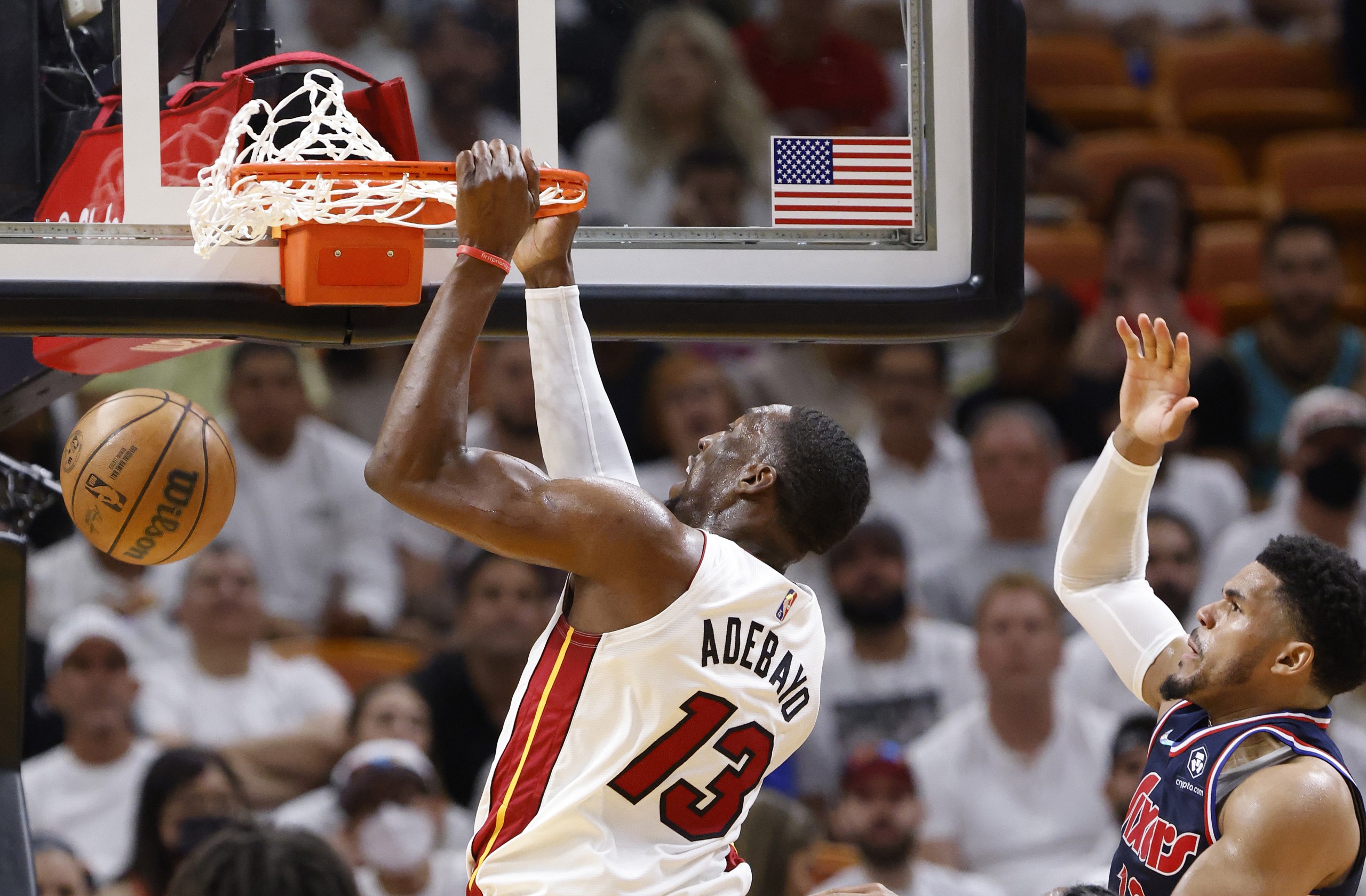 epa09923722 Miami Heat center Bam Adebayo (L) dunks around Philadelphia 76ers forward Tobias Harris (R) during the second half of game one of the NBA Eastern Conference semifinals series between the Miami Heat and the Philadelphia 76ers at FTX Arena in Miami, Florida, USA, 02 May 2022.  EPA/RHONA WISE  SHUTTERSTOCK OUT