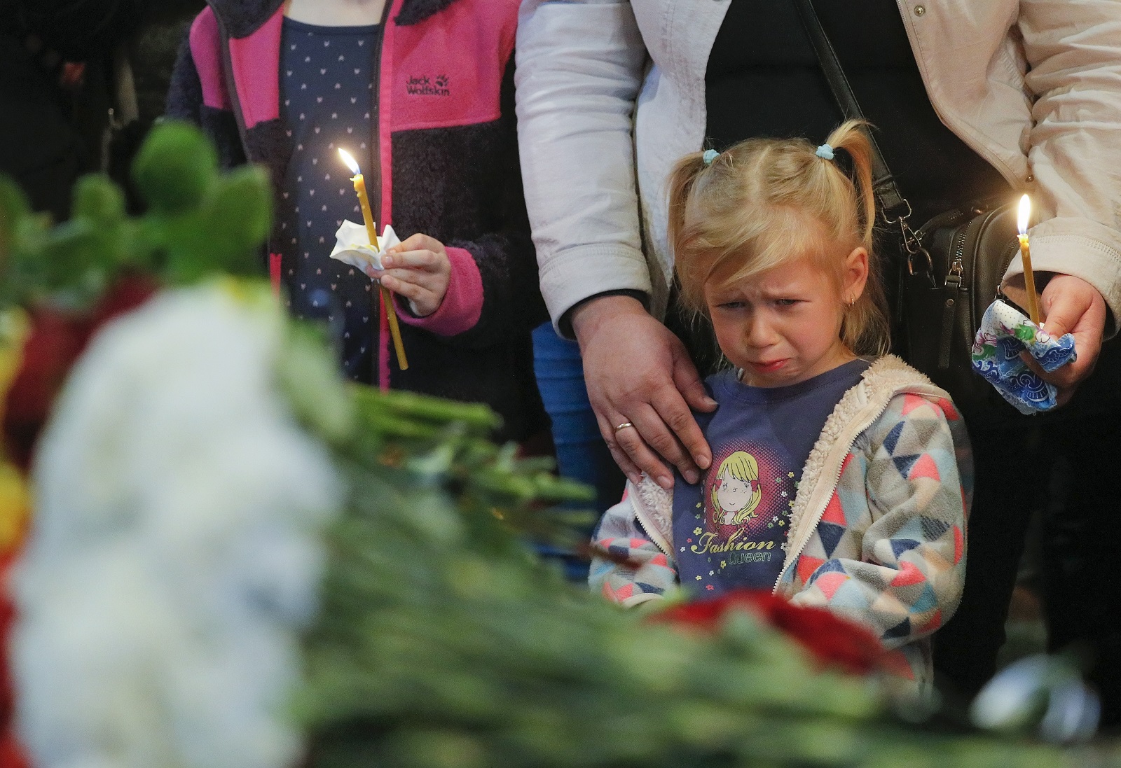 epa09926395 Ruslan's daughter Anna mourns near the coffin of her father, Ukrainian serviceman Ruslan Borovyk, during the funeral ceremony in St. Michaels Golden-Domed Monastery in Kyiv (Kiev), Ukraine, 04 May 2022. Ukrainian serviceman Ruslan Borovyk was killed in a battle in eastern Ukraine. Russian troops entered Ukraine on 24 February resulting in fighting and destruction in the country and triggering a series of severe economic sanctions on Russia by Western countries.  EPA/SERGEY DOLZHENKO