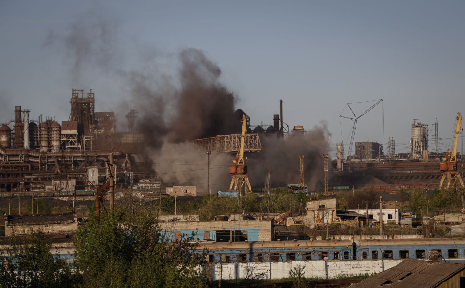 epa09932618 Smoke rises over Azovstal steel plant in Mariupol, Ukraine, 07 May 2022. According to the Interdepartmental Coordinating Headquarters of the Russian Federation for Humanitarian Response, 51 civilians, including 11 children, were evacuated from the Azovstal plant between 05 and 07 May. On 24 February, Russian troops had entered Ukrainian territory in what the Russian president declared a 'special military operation', resulting in fighting and destruction in the country. According to data released by the United Nations High Commission for the Refugees (UNHCR) on 05 May, over 5.7 million refugees have fled Ukraine seeking safety, protection and assistance in neighboring countries.  EPA/ALESSANDRO GUERRA