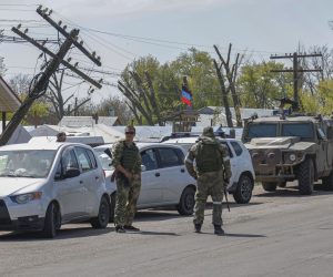 epa09932615 Russian servicemen stand guard at the temporary accommodation center for people was evacuated from Azovstal, in Bezimenoye village near Mariupol, Ukraine, 07 May 2022. According to the Interdepartmental Coordinating Headquarters of the Russian Federation for Humanitarian Response, 51 civilians, including 11 children, were evacuated from the Azovstal plant between 05 and 07 May. On 24 February, Russian troops had entered Ukrainian territory in what the Russian president declared a 'special military operation', resulting in fighting and destruction in the country. According to data released by the United Nations High Commission for the Refugees (UNHCR) on 05 May, over 5.7 million refugees have fled Ukraine seeking safety, protection and assistance in neighboring countries.  EPA/ALESSANDRO GUERRA