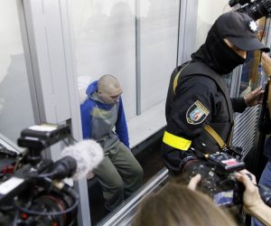 epa09944451 Russian serviceman Vadim Shishimarin (C) attends a court hearing in the Solomyansky district court in Kyiv, Ukraine, 13 May 2022. Vadim Shishimarin (21) is accused of killing an unarmed 62-year-old civilian man as Shishimarin fled with four other soldiers near Chupakha village in the Sumy area. Ukraine is holding the first war crimes trial amid the Russian invasion. Shishimarin faces possible life imprisonment if found guilty as the prosecutor's general office said.  EPA/TANYA GORDIENKO