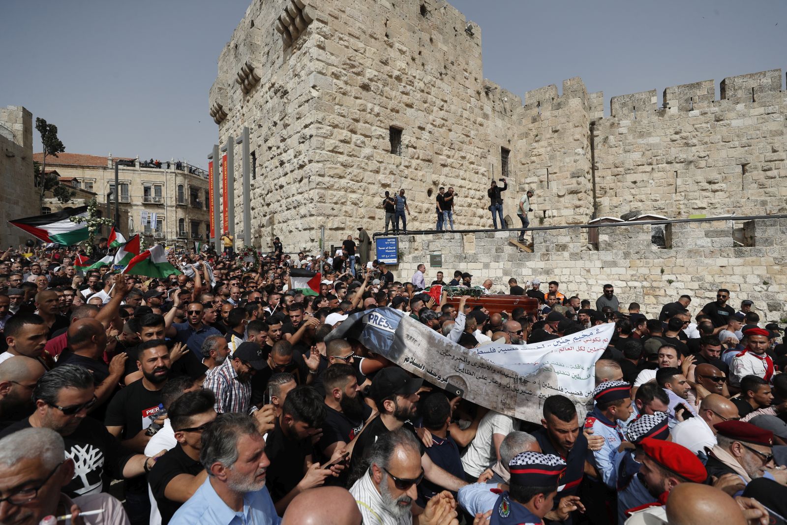 epa09944461 Mourners carry the coffin of slain American-Palestinian journalist Shireen Abu Akleh during a procession prior to her funeral in the Old City of Jerusalem, 13 May 2022. Al Jazeera journalist Shireen Abu Akleh was killed on 11 May 2022 during a raid by Israeli forces in the West Bank town of Jenin.  EPA/ATEF SAFADI