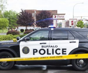 epa09947827 Police officers on the scene of a mass shooting at the Tops Friendly Market grocery store in Buffalo, New York, USA, 14 May 2022. A gunman, who has been taken into custody by police, reportedly opened fire at the market killing as many as 10 people.  EPA/BRANDON WATSON