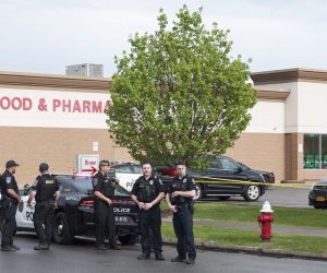epa09947828 Police officers on the scene of a mass shooting at the Tops Friendly Market grocery store in Buffalo, New York, USA, 14 May 2022. A gunman, who has been taken into custody by police, reportedly opened fire at the market killing as many as 10 people.  EPA/BRANDON WATSON