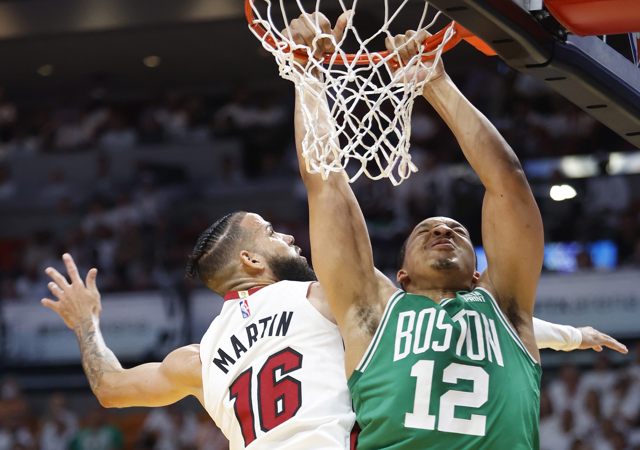 epa09959452 Boston Celtics forward Grant Williams (R) is fouled by Miami Heat forward Caleb Martin (L), during the first half of Game 2 of the NBA Eastern Conference Finals between the Miami Heat and the Boston Celtics at FTX Arena, in Miami, Florida, USA, 19 May 2022.  EPA/RHONA WISE  SHUTTERSTOCK OUT