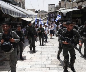 epa09983776 Israeli security forces guard participants during the Israeli right-wing 'Flag March' in the Jerusalem's Old City, Jerusalem, 29 May 2022. The annual right-wing Israeli 'Flag March' celebrating the Jerusalem Day has long been viewed by Palestinians as a provocation. Large number of Israeli police forces have been deployed in the Old city of Jerusalem and Palestinian counter protests are expected to take place in the Gaza City and West Bank.  EPA/ATEF SAFADI