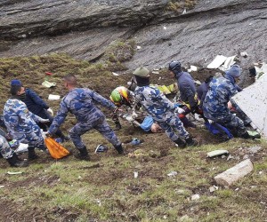 epa09986031 A handout photo made available by the Armed Police Force, Nepal shows rescue team members of the Armed Police force collecting the bodies of the victims at the site of a Tara Air twin engine plane crash, on a cliff at Thasang Village, Mustang District, Nepal, 30 May 2022. On 29 May, a Tara Air plane went missing with 22 people onboard, several minutes after takeoff.  EPA/ARMED POLICE FORCE NEPAL HANDOUT -- BEST QUALITY AVAILABLE -- ATTENTION EDITORS: GRAPHIC CONTENT -- HANDOUT EDITORIAL USE ONLY/NO SALES
