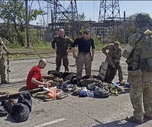 epa09956599 A still image taken from a handout video dated 17 Apirl 2022 and made available by the Russian Defence ministry press service on 18 April 2022 shows Ukrainian servicemen (C) from the besieged Azovstal steel plant preparing to be evacuated, Mariupol, Ukraine, 17 May 2022. A total of 265 Ukrainian militants, including 51 seriously wounded, have laid down arms and surrendered to Russian forces, the Russian Ministry of Defence said on 17 May 2022. Those in need of medical assistance were sent for treatment to a hospital in Novoazovsk, the ministry states further. Russian President Putin on 21 April 2022 ordered his Defence Minister to not storm but to blockade the plant where a number of Ukrainian fighters were holding out. On 24 February, Russian troops invaded Ukrainian territory starting a conflict that has provoked destruction and a humanitarian crisis. According to the UNHCR, more than six million refugees have fled Ukraine, and a further 7.7 million people have been displaced internally within Ukraine since.  EPA/RUSSIAN DEFENCE MINISTRY PRESS SERVICE/HANDOUT HANDOUT HANDOUT EDITORIAL USE ONLY/NO SALES HANDOUT EDITORIAL USE ONLY/NO SALES