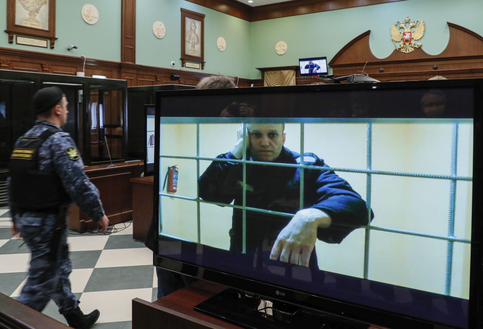 epa09971351 Russian opposition leader Alexei Navalny is shown on a monitor screen via video link from the penal colony No. 2 (IK-2) in Pokrov in Vladimir region, during a hearing of an appeal against Lefortovsky court sentence at the Moscow city court in Moscow, Russia, 24 May 2022. The Lefortovsky court sentenced politician Alexei Navalny to nine years in a strict regime colony and a fine of 1.2 million rubles for large-scale fraud and insulting the court. The Moscow city court upholded Navalny's conviction.  EPA/YURI KOCHETKOV